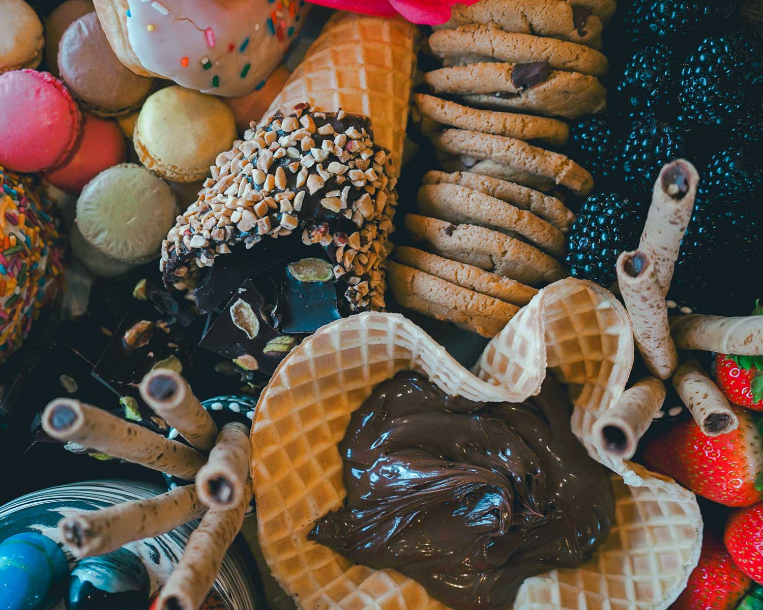 Assorted cookies and pastries on a colorful background